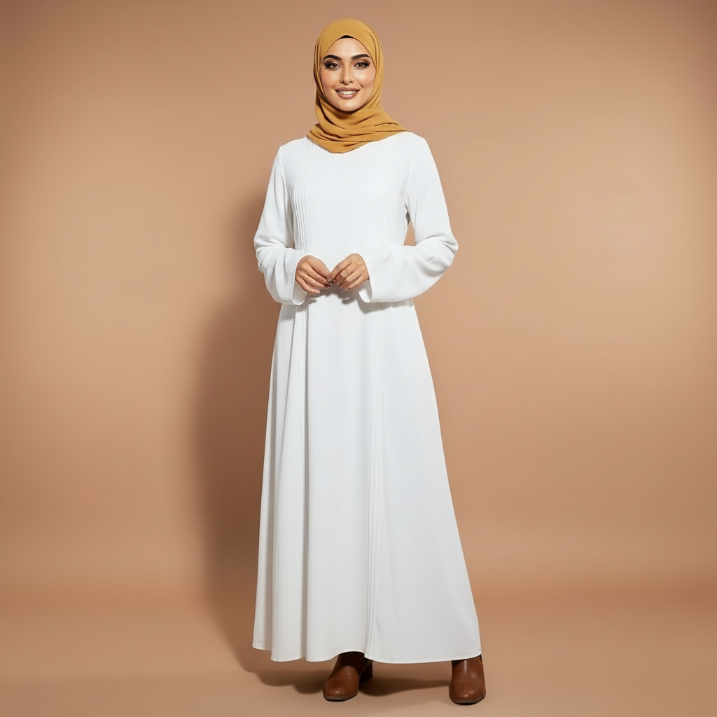 Long sleeve winter maxi dress in apricot worn by a standing hijabi model facing front, showing a round neckline, full-length sleeves, smooth surface texture, modest loose silhouette, full-length hem, and straight uninterrupted front drape
